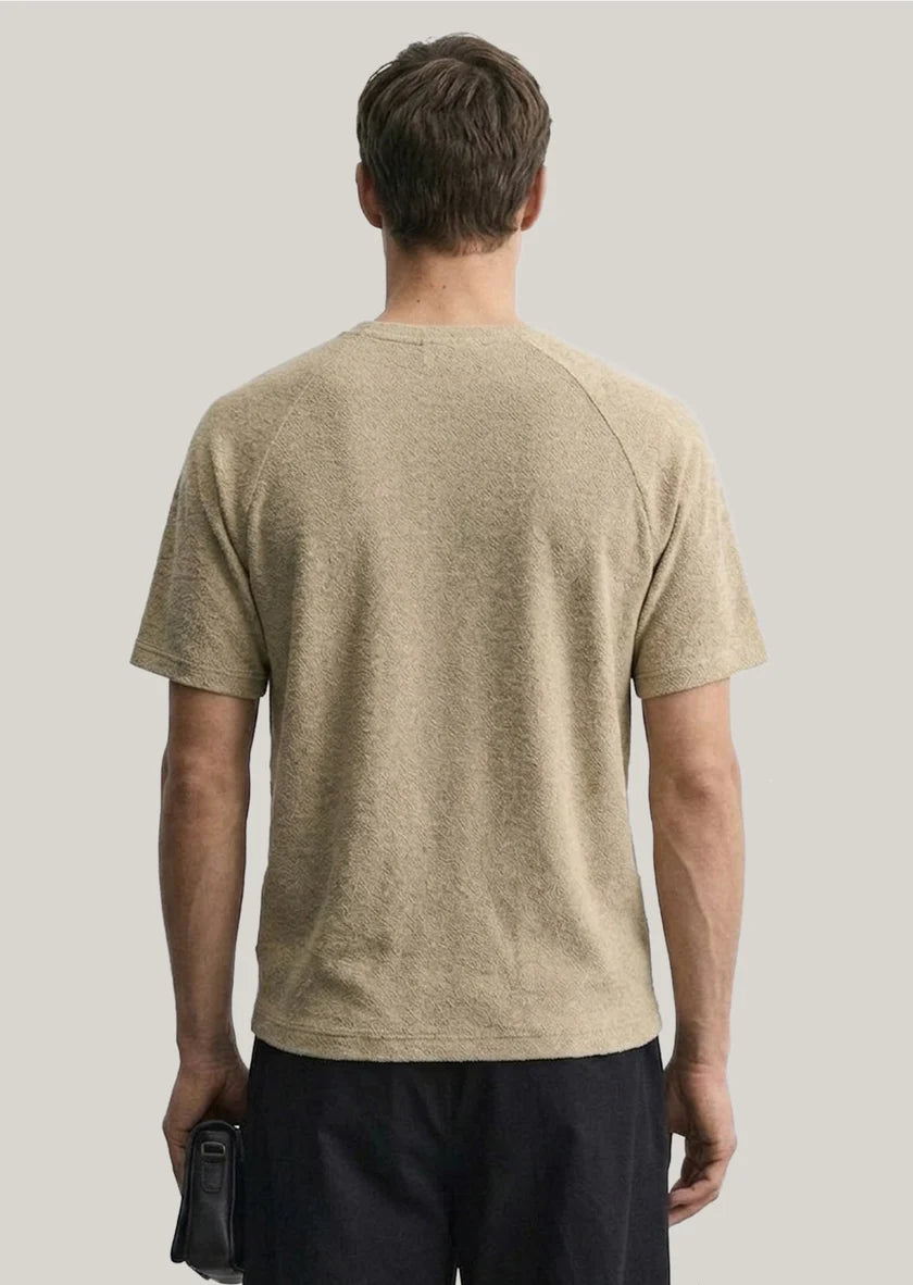 Back view of Clique Sedley Camden T-Shirt in sand color, featuring a casual fit and simple design on soft fabric.