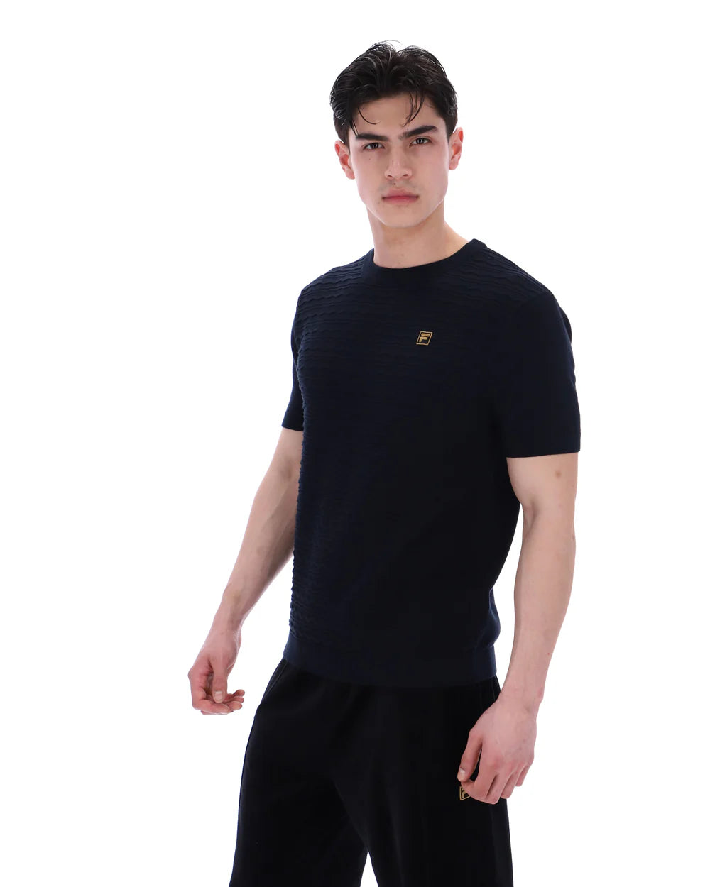 Black FILA DON Textures knitted T-shirt by Clique, featuring textured fabric and a classic fit, shown on a mannequin.
