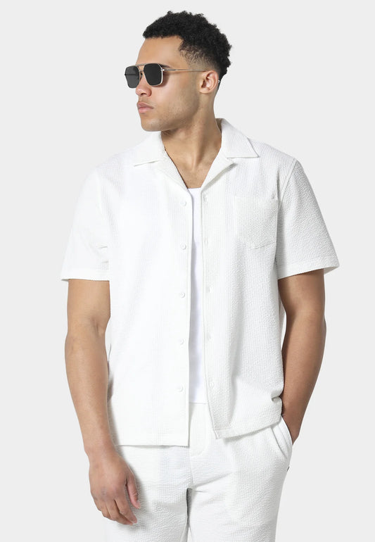 White 883Police Hullton short-sleeve shirt by Clique, featuring a classic fit and button-up front, displayed on a hanger.