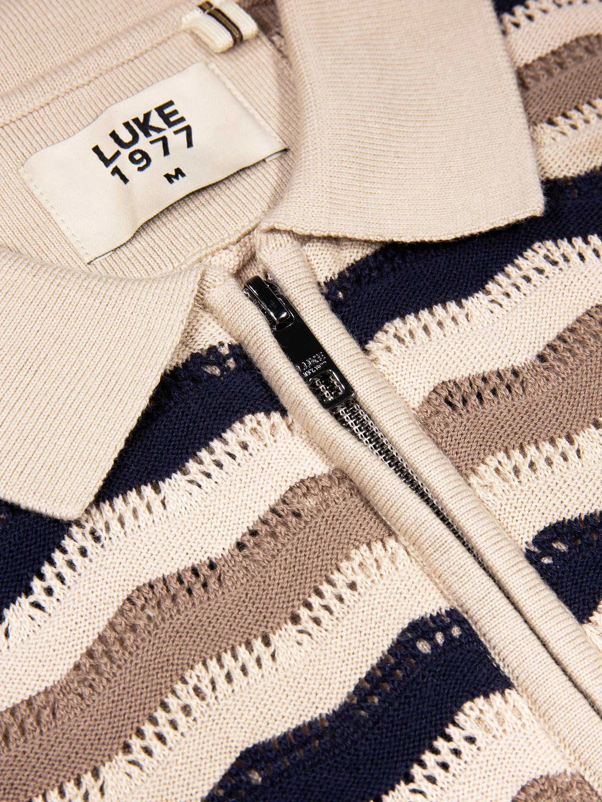 Navy, tan, and beige textured knit polo shirt by Luke 1977, featuring a classic collar and subtle knit pattern.