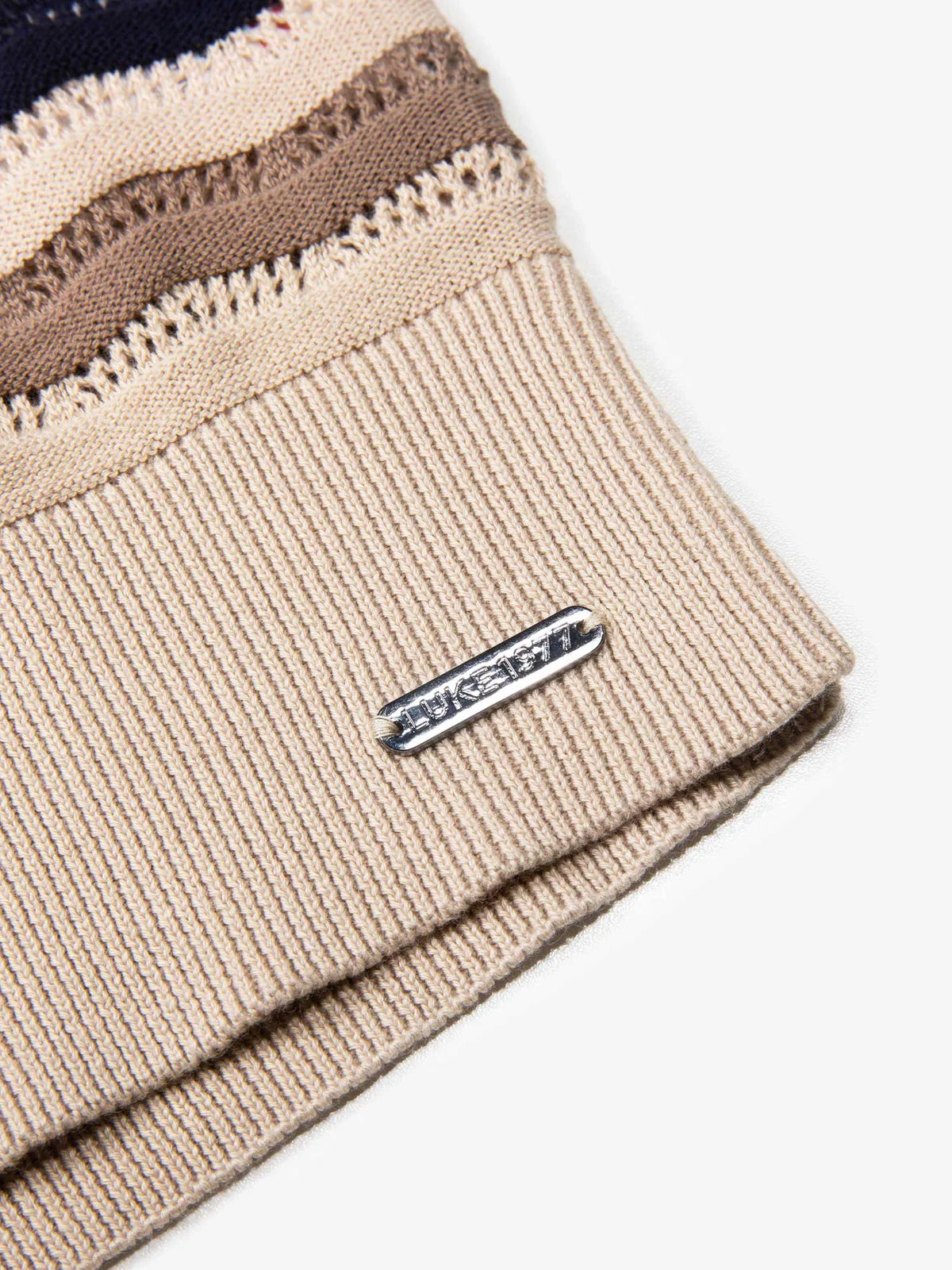 Luke 1977 Maughold textured knit polo in navy, tan, and beige with a classic collar and subtle knit pattern.