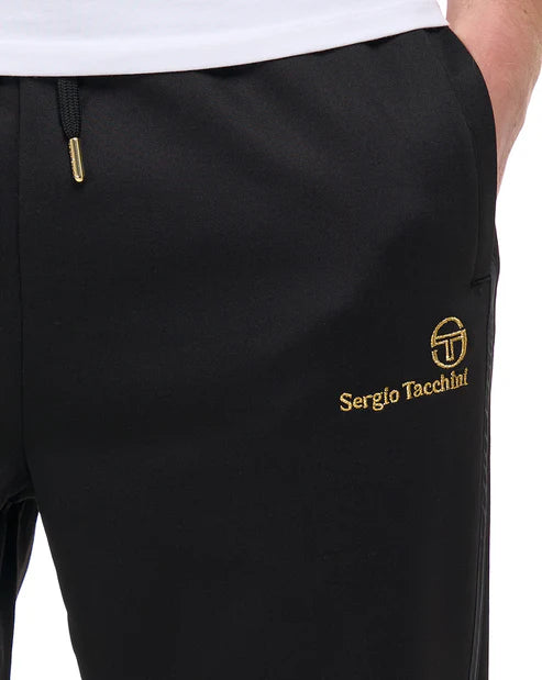 Black Sergio Tacchini Cassio Track Pants with gold accents, worn as joggers or sweats, featuring a sporty, comfortable fit.