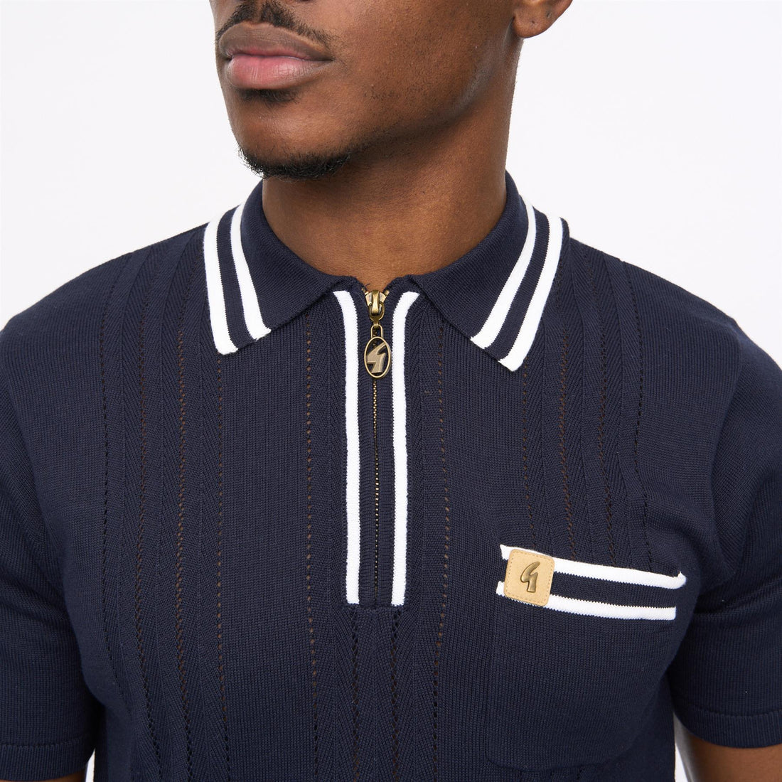 Navy Gabicci short sleeve zip neck knit polo shirt by Clique, featuring a classic polo collar and zip closure on a model.