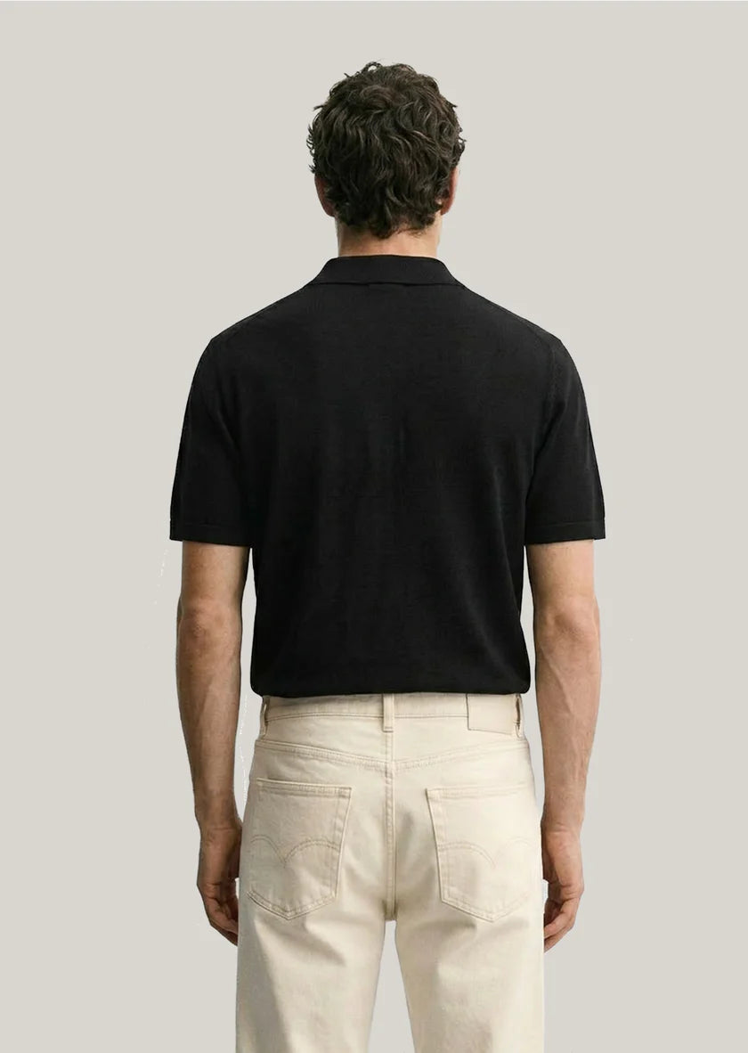 Clique Sedley Hodel black short sleeve polo shirt shown from the back, featuring a classic collar and subtle branding detail.